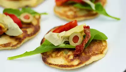 Fresh Corn Blinis with Roasted Bell Pepper, Artichoke Hearts and Arugula